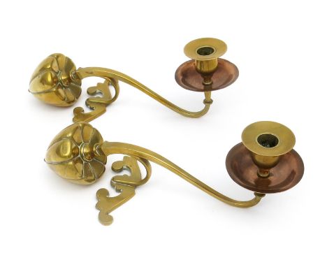 A pair of W.A.S Benson copper and brass mantelpiece candlesticks, with brass seedpod counterweight, scroll foot, the scroll s