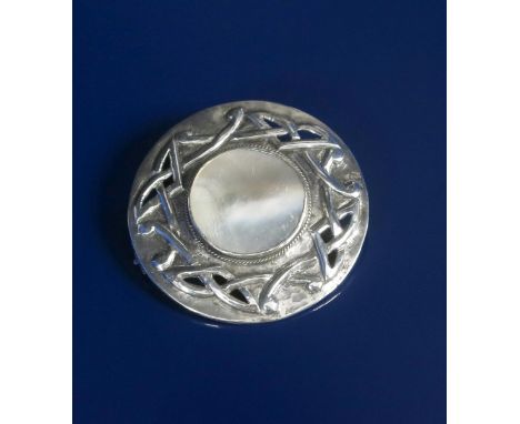 A Celtic silver and mother of  pearl brooch, circular, pierced and cast with an entrelac border, around central circular moth