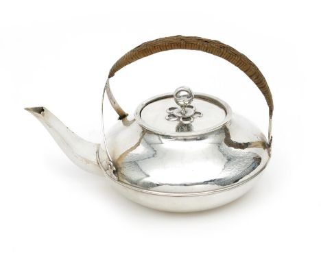 A Liberty & Co Cymric silver teapot and cover, model no.5208,  the low compressed body with over-slung wicker bound handle, t