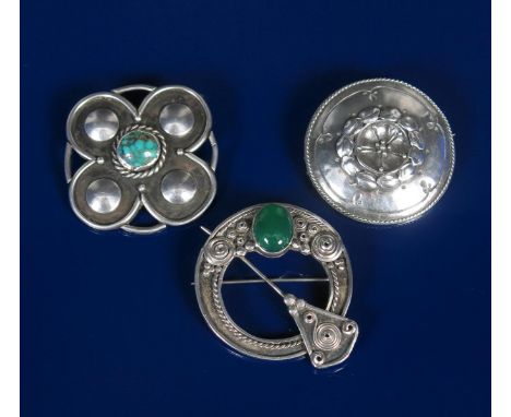 A silver and chrysoprase kilt-pin brooch, cast with geometric wirework decoration, another Celtic Revival flower brooch and a