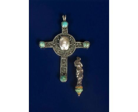 A silver and turquoise Celtic cross pendant, cast in low relief with wirework borders and decoration, set with four turquoise