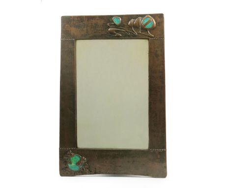 A patinated copper wall mirror possibly retailed by Liberty & Co,  rectangular section, cast in low relief with panels of Art