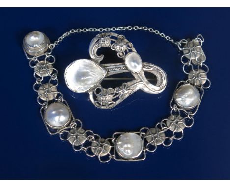 A Celtic silver and blister pearl brooch, cast and pierced with entrelac and rope panels, set with two blister pearls, and a 