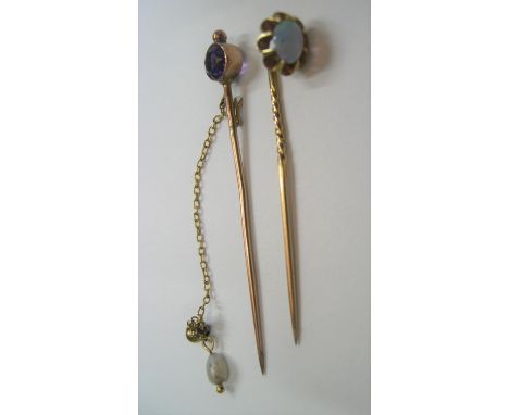 2 antique unmarked 9ct stickpins, 1 with an opal, the other amethyst,3.6 grams 