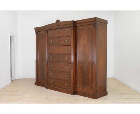 c.1830, the architectural frieze over seven drawers and twin panelled doors flanked by fluted pilasters,258cm wide68cm deep21