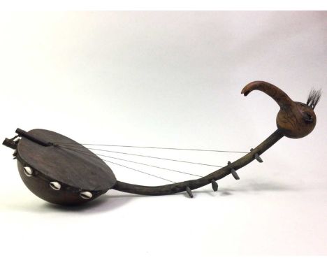 AFRICAN MANBETU-TYPE HARP OR CORDOPHONE, CIRCA MID-20TH CENTURY four-string, with carved bird's head detail and set with shel