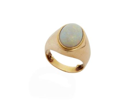  An opal ring  Collet-set with an oval cabochon opal, tapered band, indistinct marks Ring size: L/M   