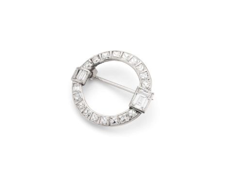  An Art Deco diamond brooch, circa 1920s  Of circular outline, channel-set with calibré French-cut diamonds, with rectangular