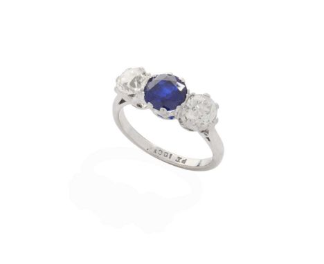  A sapphire and diamond three-stone ring  Claw-set with a round-cut sapphire and two old round-cut diamonds, plain band, stam