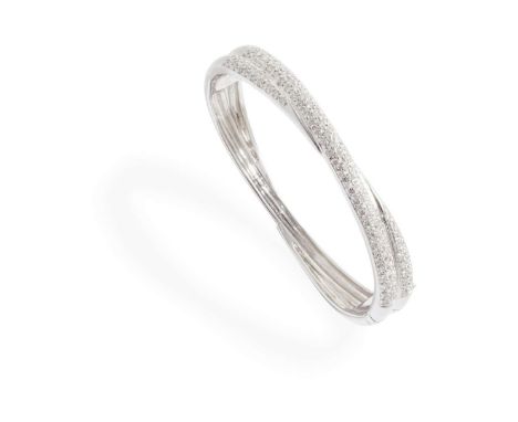  An 18ct gold diamond bangle  Of hinged design with ribbed detail, pavé-set with round brilliant-cut diamonds, UK hallmark In