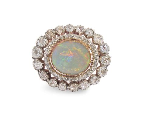  A late 19th century opal and diamond pendant/brooch, circa 1890  Claw-set with an oval cabochon opal, in a double border of 
