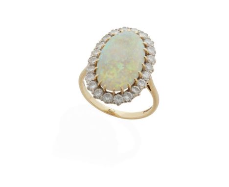  An 18ct gold opal and diamond cluster ring  Claw-set with an oval opal cabochon, in a border of round brilliant-cut diamonds