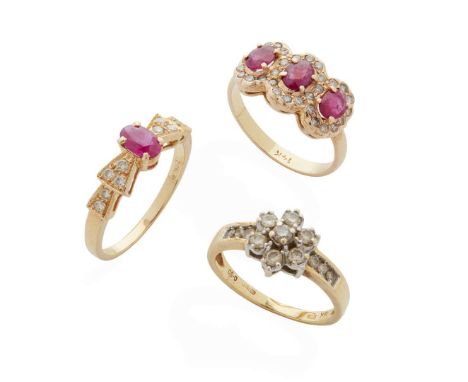  A collection of ruby and diamond rings  Including an 18ct gold diamond cluster ring, UK hallmark; a three-stone ruby ring in