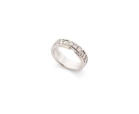  Tiffany & Co: A diamond 'Atlas' ring, circa 1995  The band with Roman numeral detail, set with three round brilliant-cut dia