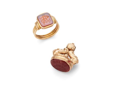  A hardstone seal and associated ring  The seal with engraved carnelian matrix engraved DEEDS NOT WORDS, scrolling surmount, 