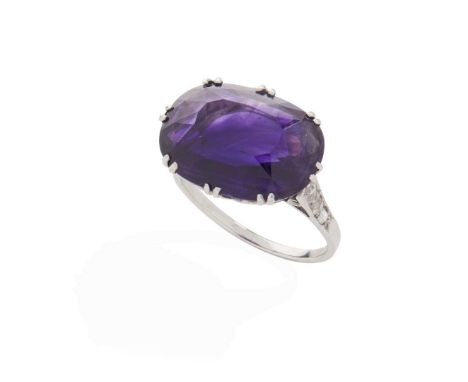  An amethyst and diamond cocktail ring  Claw-set with a horizontal cushion-cut amethyst, each shoulder set with eight-cut dia