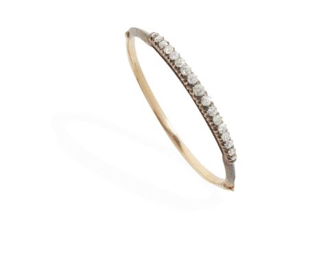  A diamond bangle  Of hinged design, claw-set with seventeen graduated old round-cut diamonds, unmarked Internal diameter: 5.