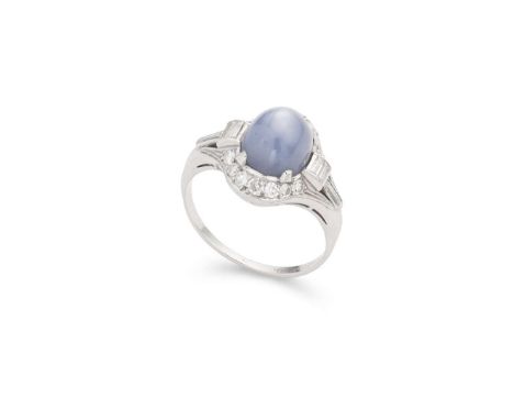  A star-sapphire and diamond cluster ring  Claw-set with an oval cabochon star-sapphire, in a border of eight-cut and baguett