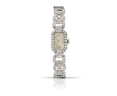  An early 20th century diamond cocktail watch  The rectangular dial with Arabic numerals, bezel-set with eight-cut diamonds, 