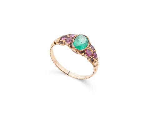  An emerald and ruby ring  Set with an oval-cut emerald, each shoulder set with three cushion-cut rubies, engraved detail to 