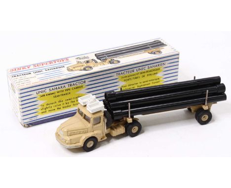French Dinky Toys No. 893 Unic Sahara Pipe Transporter, in beige body with white roof, and six black pipes, in the original b
