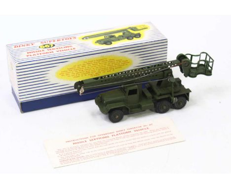A Dinky Toys No. 667 Military Missile Servicing Platform vehicle comprising a green body with matching green hubs, in the ori