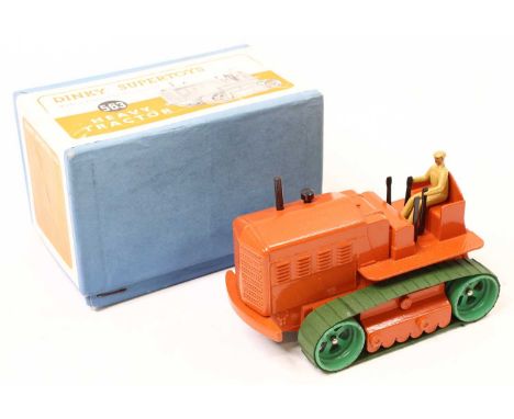Dinky Toys No. 563 Heavy Tractor, comprising orange body with tan driver and green tracks, housed in the original blue card b