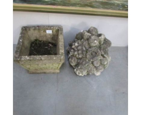 A garden pot and a gate post finial.