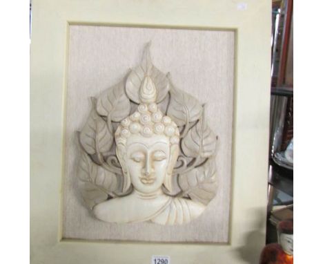 A framed carved wood Indian deity portrait relief, frame 50 x 61 cm.