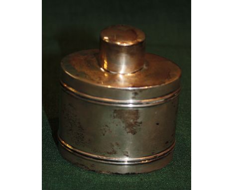 AN OVAL SHAPED SILVER TEA CADDY with reeded decoration and press on lid, 9cm high, marks rubbed, 2.5 troy oz