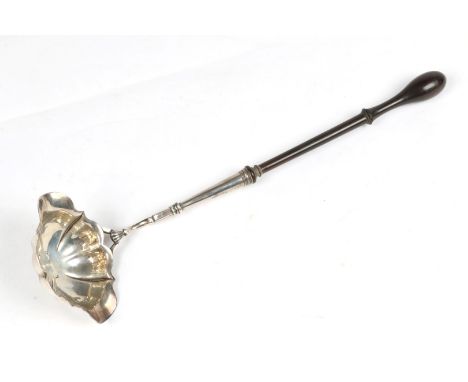 A GEORGE II SILVER PUNCH LADLE with shaped bowl with two pouring lips and turned ebonised handle, 33cm long, London 1752