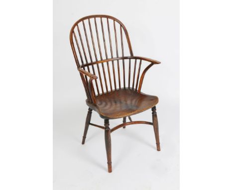 A 19TH CENTURY YEW AND ELM WINDSOR ARMCHAIR with stick back and saddle seat, crinoline stretcher and turned legs, 55cm wide