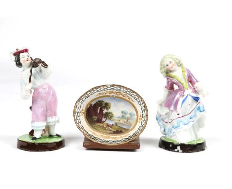 AN EARLY 19TH CENTURY SMALL ENAMEL DISH of oval pierced form painted with a pastoral river landscape; together with wooden st