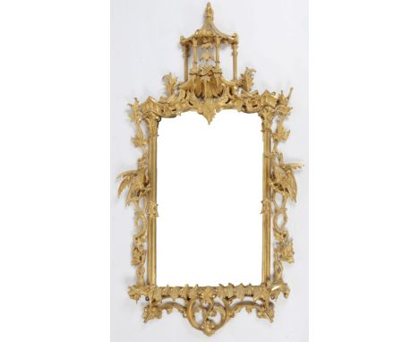 A CHINESE CHIPPENDALE STYLE WALL MIRROR, the giltwood frame with pagoda crest, the sides decorated with ho-ho birds upon inte