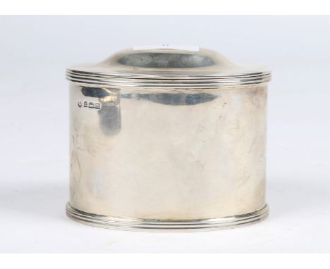 A GEORGE V OVAL SILVER TEA CADDY of plain form and with a domed hinged lid, 10cm wide, Birmingham 1911 by Hutton & Sons Ltd, 