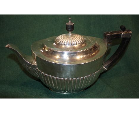 A LATE VICTORIAN OVAL SHAPED SILVER TEAPOT with fluted lower body, ebonised handle and matching finial, 15cm high, London 189