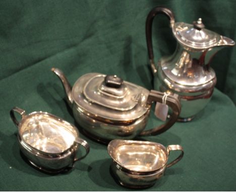 A FOUR PIECE SILVER TEA SET with an oval shaped teapot with scrolled ebonised handle, 24cm high, matching cream jug, a two ha