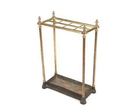 A VICTORIAN BRASS STICK STAND with eight divisions, cast iron base and drip pan, 44cm wide