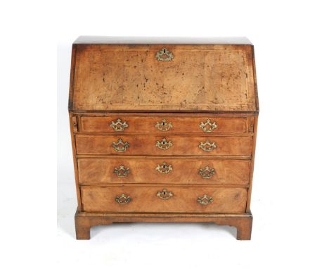 A MID 18TH CENTURY FIGURED WALNUT BUREAU with fitted interior over four long drawers with brass handles and bracket feet, 91c