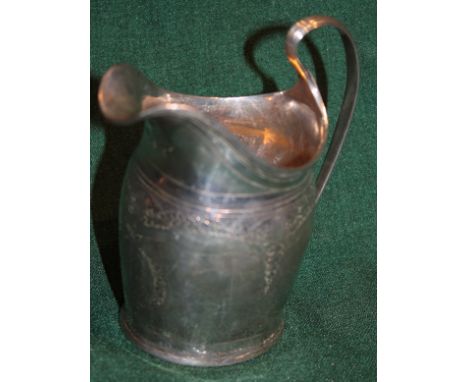 A GEORGE III SILVER HELMET JUG with a reeded whip lash handle and engraved with foliate decoration, 11.5cm high, London 1796 