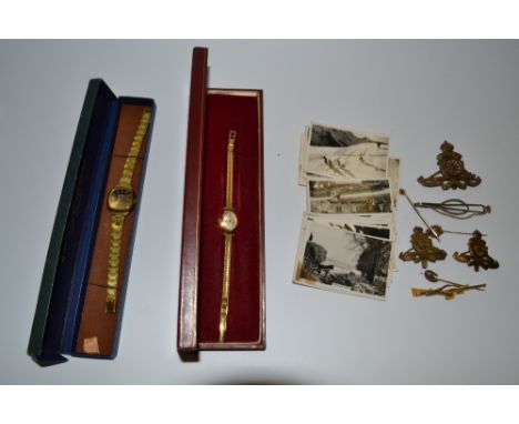 A late 19th century 9ct gold stick pin, seed pearl to centre;  others, plated;  cap badges;  Senior Service cigarette cards p