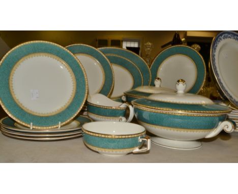 A Globe pottery part dinner service, decorated in bands of green and gold c.1930