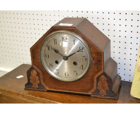 An early 20th century mantel clock, stepped oak case, silvered dial, Arabic numerals, eight day chiming movement c.1920