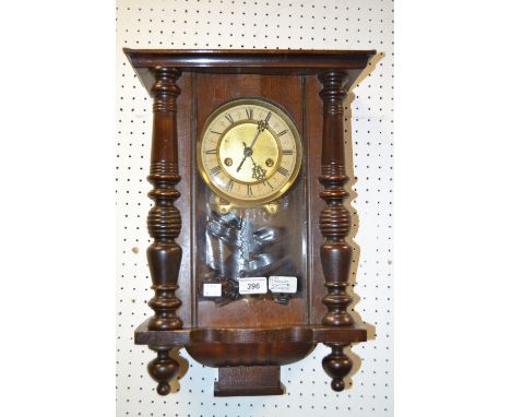 An early 20th century walnut Vienna wall clock of small proportions c.1900