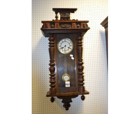 An early 20th century Vienna wall clock, moulded cresting, enamel dial with Roman numerals, 97cm high
