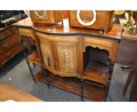 An Edwardian rosewood salon cabinet inlaid with boxwood scrolling tendrils, central bow fronted section with two cupboard doo