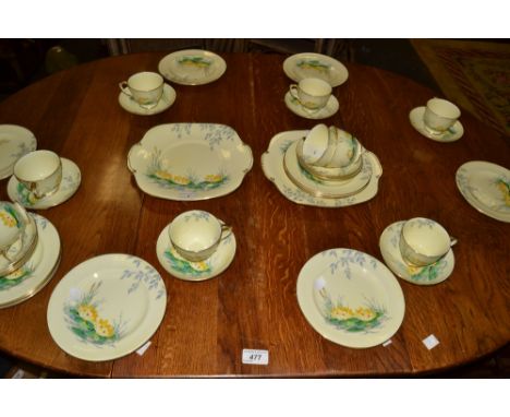 A Crown Staffordshire tea service decorated with water lilies on a yellow ground 