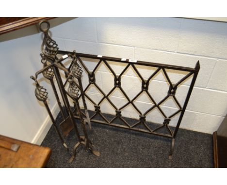 A wrought iron fireguard and fireside companion set