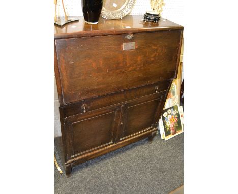 A 1930's Globe Wernicke bureau, the drop down front inscribed with presentation plaque over drawer and doors