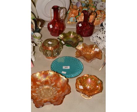 A Victorian cranberry glass ewer, another; a carnival glass bowl, others, an Edwardian glass and copper light shade